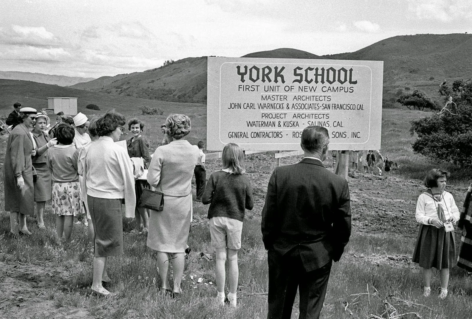 black and white photo of crowd at new building site for school