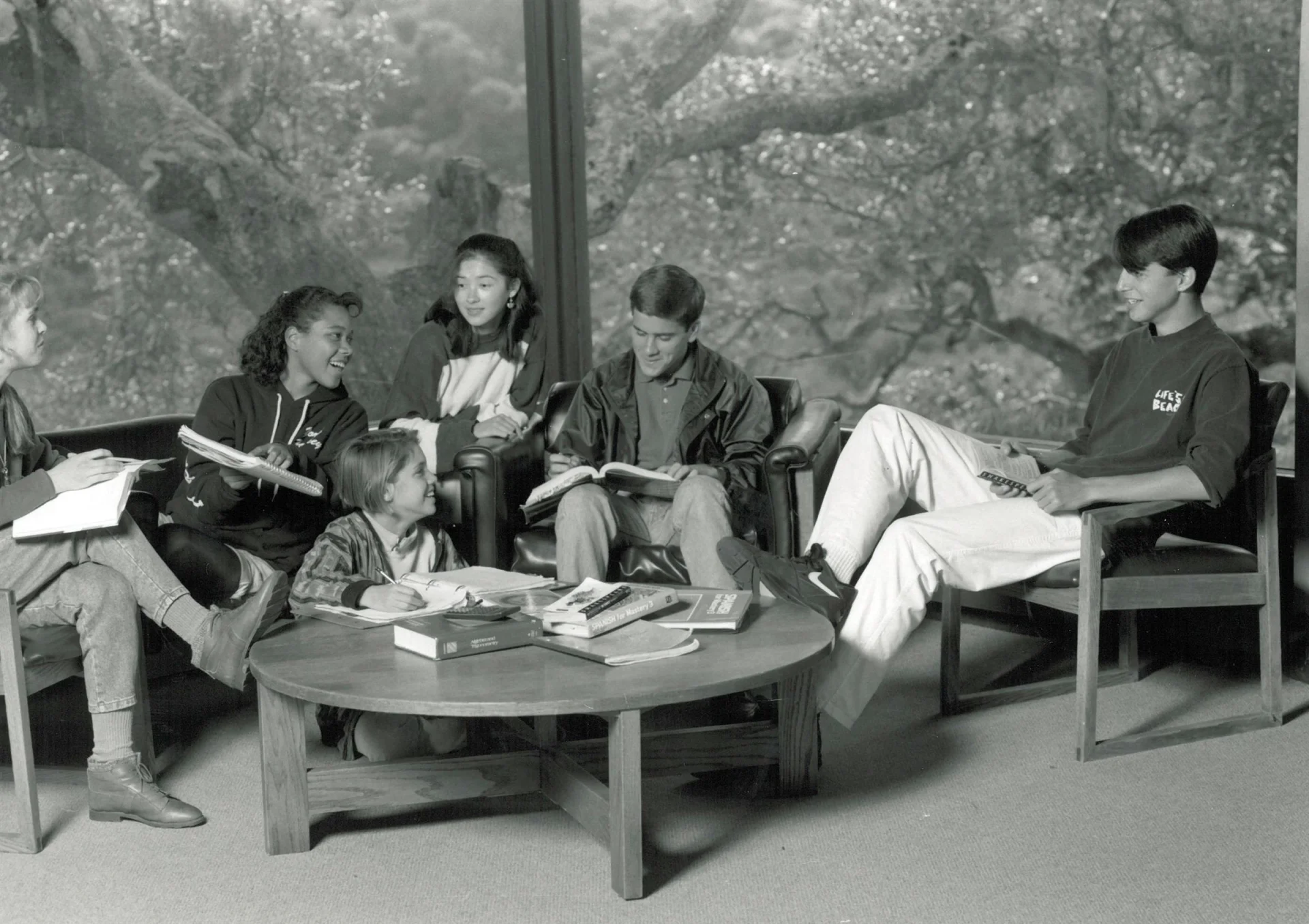 black and white photo of students sitting around a table