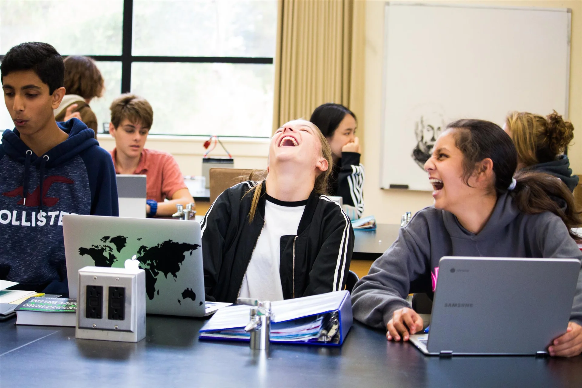 group of students laughing together in classroom